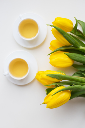 beautiful yellow tulips, two cups of green tea, springの写真素材