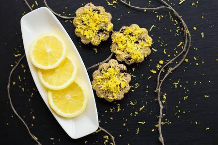 lemon cupcakes on a black background with lemon peel, close-upの写真素材
