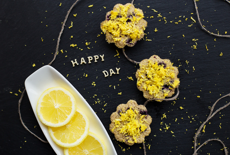 lemon cupcakes on a black background - inscription happy dayの写真素材