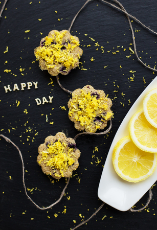 lemon cupcakes on a black background - inscription happy dayの写真素材