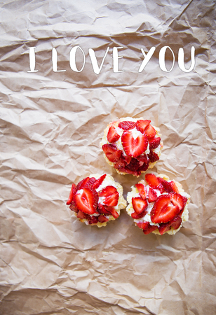 Beautiful and bright cupcakes with strawberries, inscription I love you.の写真素材