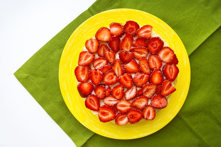 Beautiful strawberry cake is on the table, green napkin, close-up.の写真素材