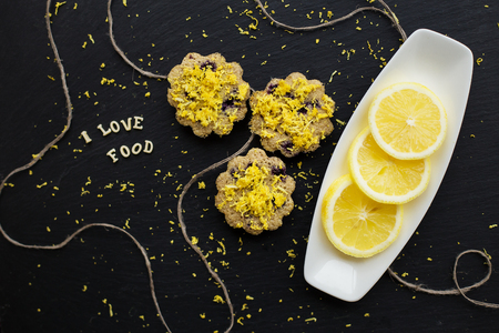 lemon cupcakes on a black background with lemon zest, inscription, I love foodの写真素材