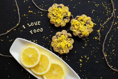 lemon cupcakes on a black background with lemon zest, inscription, I love foodの写真素材
