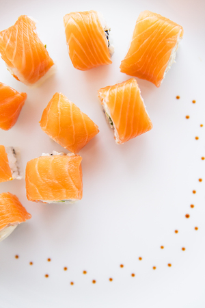 Sushi roll with salmon, philadelphia on a white plate, top view. Close-upの写真素材