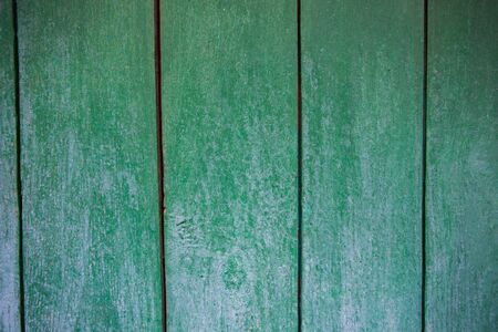 Shabby and very old wooden fence - cracked paint.の写真素材