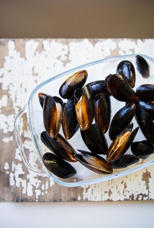 Fresh mussels on an old wooden white table