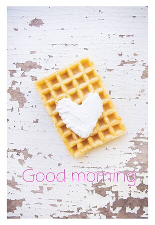 Very beautiful Belgian waffles on an old table-good morning inscriptionの写真素材