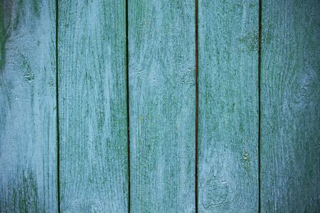 Shabby and very old wooden fence - cracked paint.の写真素材