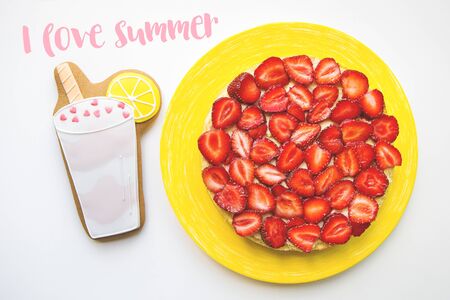 Strawberry cake is on the table with cookies in the form of a cocktail, the inscription I love summer.の写真素材