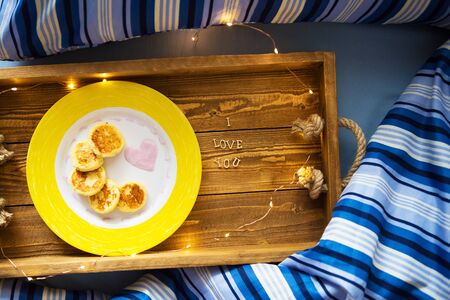 cheese pancakes on a tray-breakfast in bed, the morning of St. Valentine's Day-close-up.の写真素材