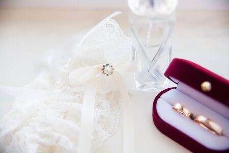Wedding ring on the bride's wedding garter and spiritsの写真素材