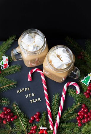 A cup of coffee with marshmallows, Christmas ornaments and candy. Close-upの写真素材