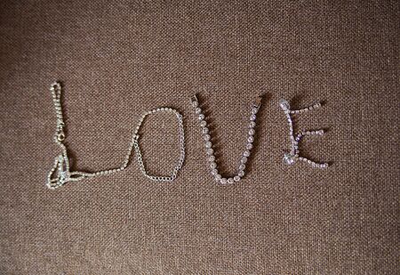 Beautiful silver chain in the shape of a heart on the couchの写真素材