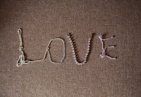 Beautiful silver chain in the shape of a heart on the couchの素材 [FY310132237009]