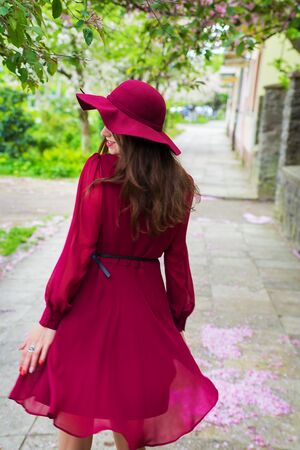 girl in red dress and hat - rear viewの写真素材