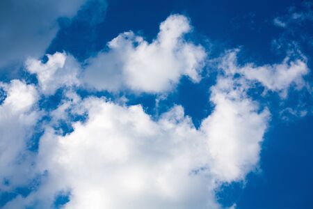 Blue sky background with white beautiful cloudsの写真素材