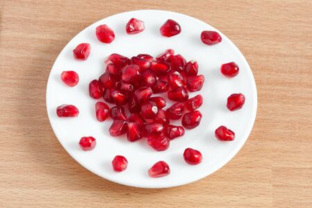 pomegranate seeds on a plateの写真素材