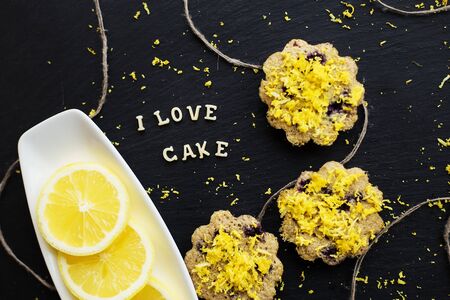 lemon cupcakes on a black background with lemon zest, inscription I love cake, close-upの写真素材