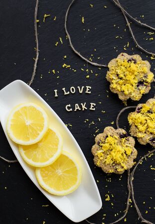 lemon cupcakes on a black background with lemon zest, inscription I love cake, close-upの写真素材