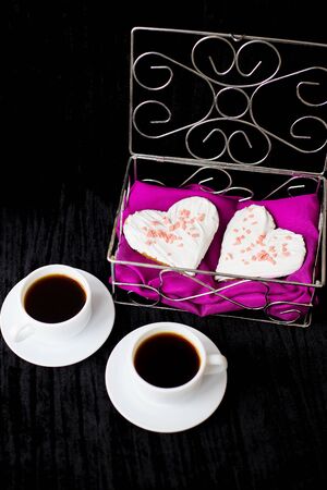 Valentine's Day: two cups of coffee and biscuits in the form of heart.の写真素材