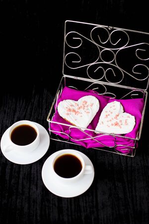 Valentine's Day: two cups of coffee and biscuits in the form of heart.の写真素材