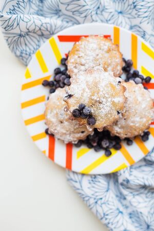 Blueberry muffins on plate and bright floral napkin, close-upの写真素材