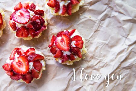 Beautiful and bright cupcakes with strawberries, inscription I love you.の写真素材