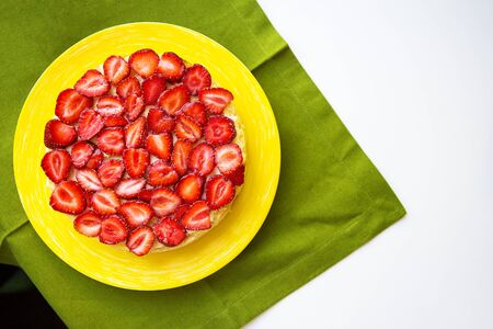 Beautiful strawberry cake is on the table, green napkin.の写真素材