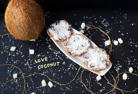 coconut muffins on a black background with words like candied fruits and coconutsの写真素材