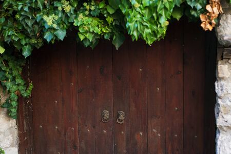 Old brown wooden door from medieval era.の写真素材