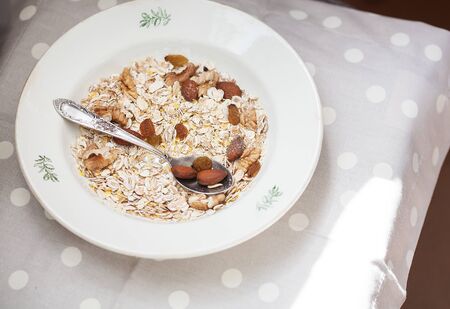 Oatmeal in bowl with nuts, useful foodの写真素材