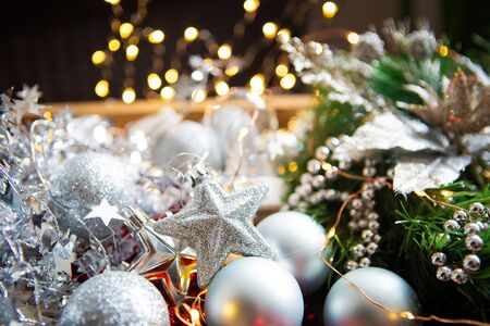 Christmas background. Fir branches, Christmas decor, cones, red and silver balls, red beads.の写真素材