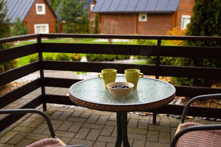 Two cups of coffee on the table on the street. Terrace, vacation, mountains, forest.の写真素材