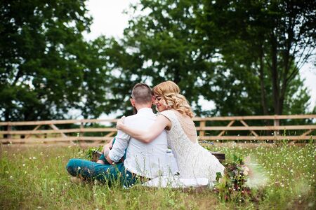 beautiful bride and groom hipster are sitting on nature, rustic style.の写真素材
