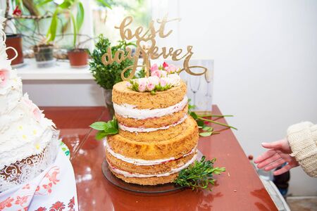 big beautiful wedding cake with fresh rosesの写真素材