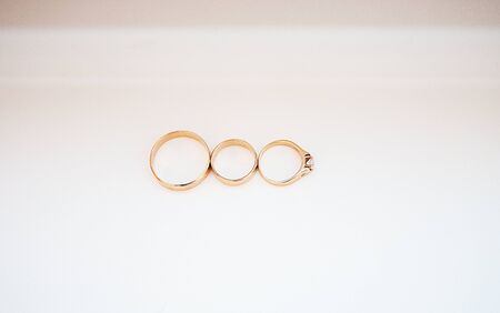three wedding rings on a white backgroundの写真素材