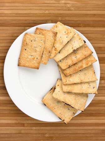 yellow cookies on white plate on bamboo napkinの写真素材