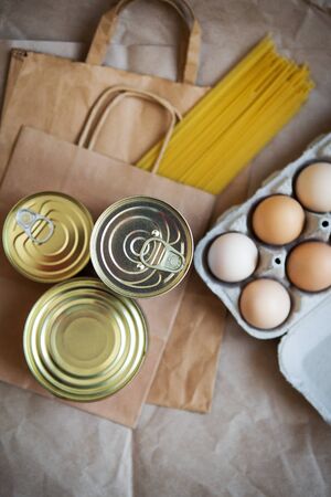 Eggs, canned food, pasta, products in environmentally friendly craft packages. Vegetarian healthy organic foods from the market. Donation, help for those in need.の写真素材
