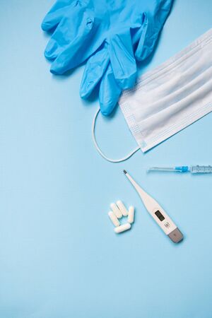 Medical mask, gloves, thermometer protection against viruses. A new outbreak of coronavirus covid-19. The fight against coronavirus. The danger of coronavirus and the risk to public healthの写真素材