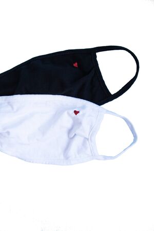 The new coronavirus COVID-19, a mask for protection against viruses, white and black. Isolation on a white background. The concept of coronavirus quarantine. Sit at home, save your lifeの写真素材