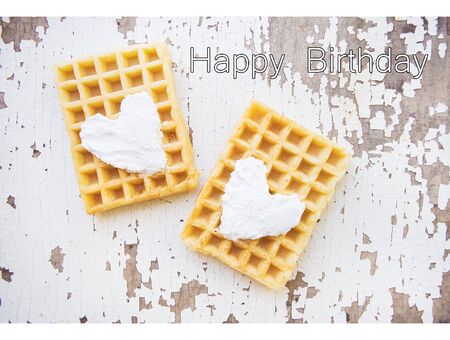 Very beautiful Belgian waffles on an old table-inscription of a happy birthdayの写真素材