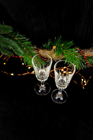 New Years concept, lights, Christmas tree, New Year decorations, two champagne glasses. Festive mood.の写真素材
