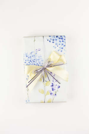 Christmas gift box with festive decor in silver tones. Close-up, top viewの写真素材