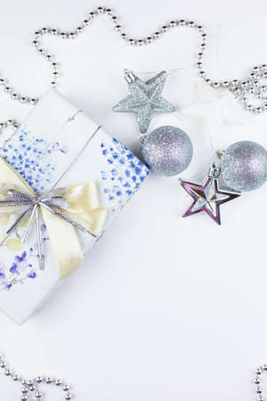 Very nice festive decor. Christmas gift box with festive decor in silver tones. Close-up, top viewの写真素材