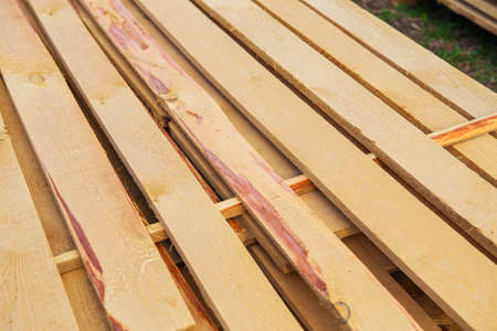 Building material in the form of fresh wooden planks at a road repair site. The repair process. View from aboveの写真素材