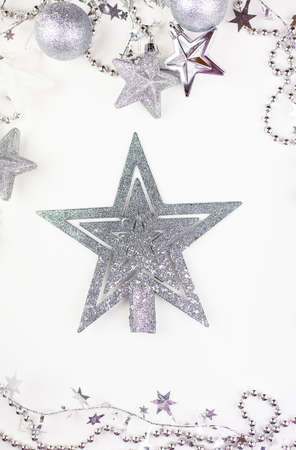 Festive mood, preparation for the holiday. New Year's festive decor in silvery colors, with a silver star in the center of the frameの写真素材