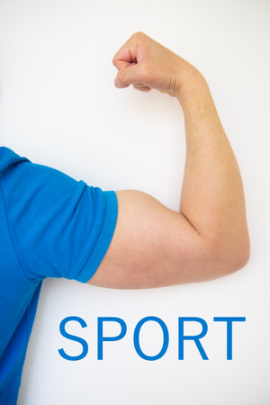 Close up of a handsome male hand showing biceps on a white background. The inscription sport. Health and sport concept.の写真素材