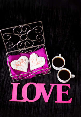 two cups of coffee, cookies in the form of heart inscription love.の写真素材