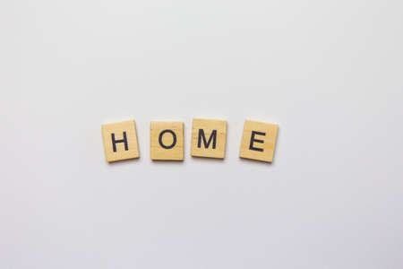 Decorative wooden letters forming the word home on a white background, top viewの写真素材
